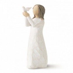 Small brunette girl figurine in white dress holding up white dove