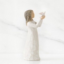Small brunette girl figurine in white dress holding up white dove