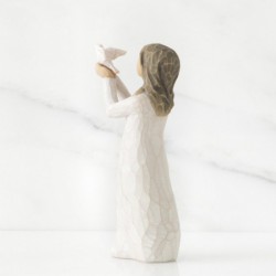Small brunette girl figurine in white dress holding up white dove