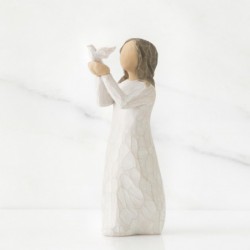 Small brunette girl figurine in white dress holding up white dove