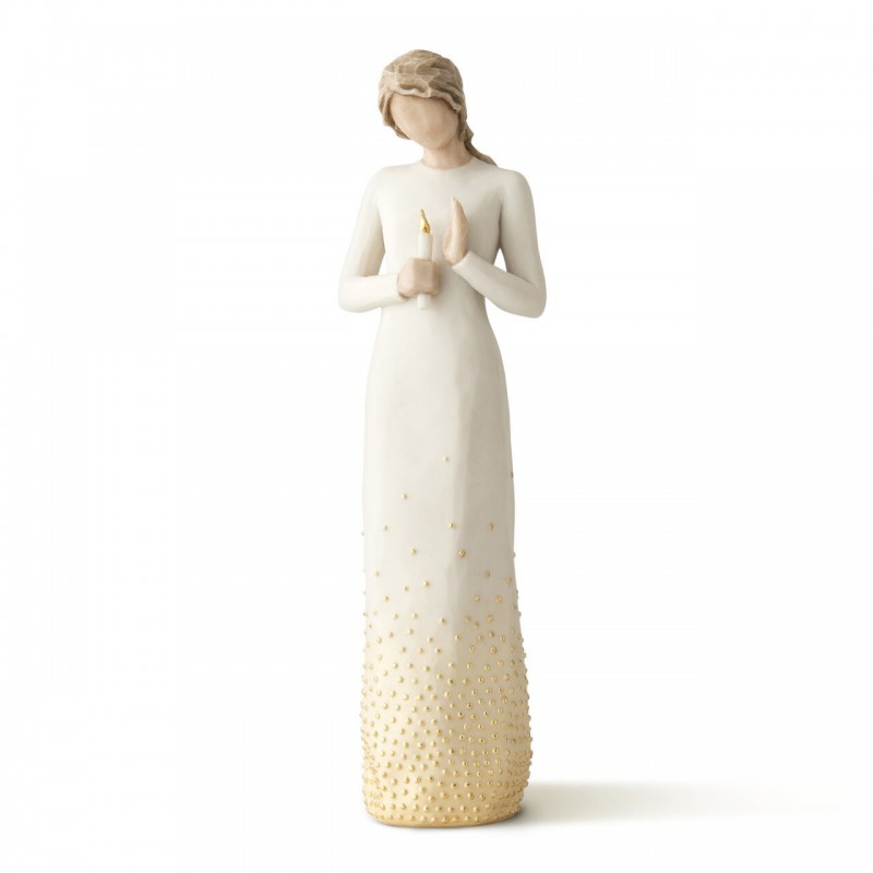 Faceless woman figurine wearing all white dress with her hands holding a candle