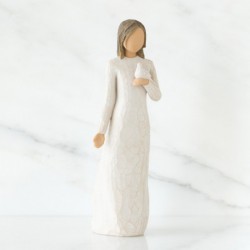 Brunette girl figurine in white dress holding white dove with one arm