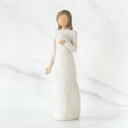 Brunette girl figurine in white dress holding white dove with one arm