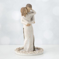 Woman figurine in white dress hugging man figurine - standing on white round plaque