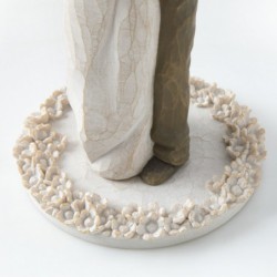 Woman figurine in white dress hugging man figurine - standing on white round plaque