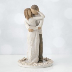 Woman figurine in white dress hugging man figurine - standing on white round plaque