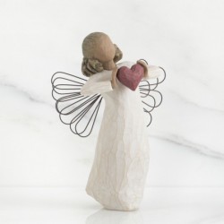 Faceless woman angel figurine wearing white dress holding pink heart up