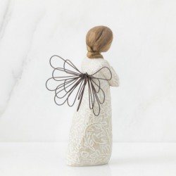 Angel figurine in white dress with black wire wings holding arms crossed on her chest