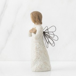 Angel figurine in white dress with black wire wings holding arms crossed on her chest