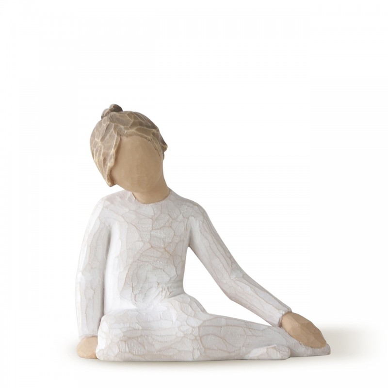 Faceless girl figurine sitting with hands on her legs