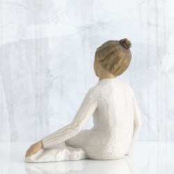 Faceless girl figurine sitting with hands on her legs