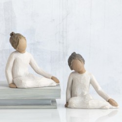 Faceless girl figurine sitting with hands on her legs