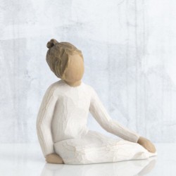 Faceless girl figurine sitting with hands on her legs