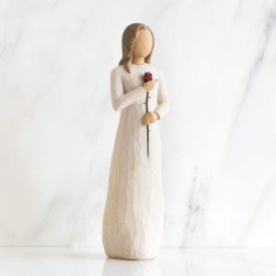 Woman figurine holding a rose in her hand