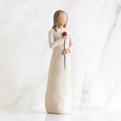 Woman figurine holding a rose in her hand
