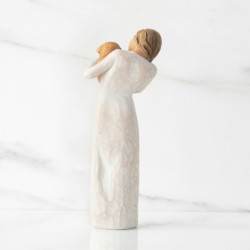 Standing female figure in cream dress