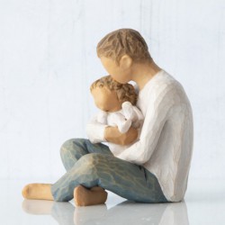  seated male figure in cream shirt and blue jeans