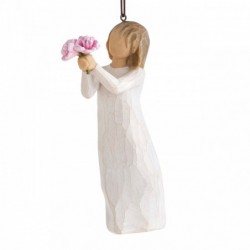 Front view of female figure in cream dress holding out small bouquet of pink peonies